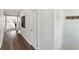 Hallway with wood floors and white walls leading to rooms in the house at 2964 Greyhawk Ln # 160, Cumming, GA 30040