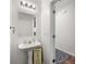 Compact powder room with pedestal sink and stylish decor at 2964 Greyhawk Ln # 160, Cumming, GA 30040