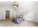 Bright bedroom with neutral carpet, a ceiling fan, and an open closet at 2964 Greyhawk Ln, Cumming, GA 30040