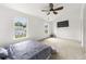 Spacious bedroom with carpet floors, natural light, and a ceiling fan at 2964 Greyhawk Ln, Cumming, GA 30040