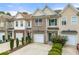 Charming townhome with brick accents, tidy landscaping, and attached one-car garage at 2964 Greyhawk Ln, Cumming, GA 30040