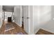 Hallway entrance to half bathroom with hardwood floors at 2964 Greyhawk Ln, Cumming, GA 30040