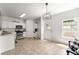 A cozy kitchen featuring stainless steel appliances, white cabinetry, and an adjacent door at 2964 Greyhawk Ln, Cumming, GA 30040