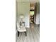View of the entryway with gray floors, a white chair, and lamp visible from the opened front door at 3233 Rockmill Dr, Ellenwood, GA 30294