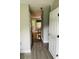 View of the entryway, with gray and brown floors, from the open front door into the dining area at 3233 Rockmill Dr, Ellenwood, GA 30294