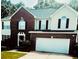 Charming two-story home with brick and vinyl siding, a well-manicured lawn, and an attached two-car garage at 3233 Rockmill Dr, Ellenwood, GA 30294