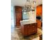 The kitchen features tile flooring, wood cabinets, a refrigerator, and a kitchen island at 3233 Rockmill Dr, Ellenwood, GA 30294