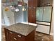 The kitchen offers a spacious refrigerator and wooden cabinetry with a door to another room in view at 3233 Rockmill Dr, Ellenwood, GA 30294