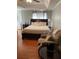 Spacious bedroom featuring a large bed, chair, a ceiling fan, and hardwood floors at 3233 Rockmill Dr, Ellenwood, GA 30294