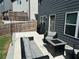 Backyard patio area with a gas fire pit, stamped concrete and dark wicker patio furniture at 370 Winston Cir, Canton, GA 30114