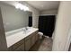 Bathroom with a large vanity, a single sink, and a shower-tub combo with black curtain at 370 Winston Cir, Canton, GA 30114