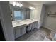 Bathroom featuring double sinks, vanity space, and a separate soaking tub with neutral colors at 370 Winston Cir, Canton, GA 30114
