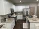 Bright kitchen featuring white cabinets, granite countertops, and stainless steel appliances at 370 Winston Cir, Canton, GA 30114