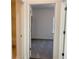 View of bedroom with neutral carpet, leading to a full ensuite bathroom at 3865 Shelleydale Dr # 82, Powder Springs, GA 30127