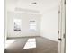 Bright bedroom with tray ceiling, gray carpet, and natural light from two large windows at 3865 Shelleydale Dr # 82, Powder Springs, GA 30127