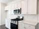 Updated kitchen with a gas stove, quartz counters and sleek stainless steel appliances at 3865 Shelleydale Dr # 82, Powder Springs, GA 30127