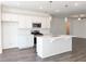 Bright, open kitchen with white cabinets, stainless steel appliances, and island seating at 3865 Shelleydale Dr # 82, Powder Springs, GA 30127