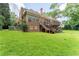 Charming brick home featuring a raised deck and large backyard, perfect for outdoor enjoyment and relaxation at 5435 Chelsen Wood Dr, Duluth, GA 30097