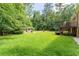 Spacious backyard featuring a charming outbuilding and a multi-level deck, offering a serene outdoor retreat at 5435 Chelsen Wood Dr, Duluth, GA 30097