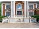 Up-close view of a stately brick home featuring classic columns, a grand entrance, and refined architectural details at 5435 Chelsen Wood Dr, Duluth, GA 30097