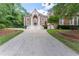 Striking two-story brick home with columns and a spacious front yard, offering a grand and inviting appeal at 5435 Chelsen Wood Dr, Duluth, GA 30097