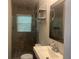 A bathroom featuring a large vanity, shower and decorative shelves at 1413 David Cir, Decatur, GA 30032