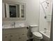 Bathroom featuring a tub-shower combo, a decorative mirror and white vanity at 1413 David Cir, Decatur, GA 30032
