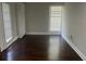 Cozy bedroom featuring hardwood floors and neutral walls, filled with natural light from the windows at 1413 David Cir, Decatur, GA 30032