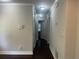 Bright hallway featuring neutral walls, white trim, and wood flooring at 1413 David Cir, Decatur, GA 30032