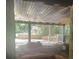 View of outdoor patio with stone features and covered ceiling overlooking backyard at 1413 David Cir, Decatur, GA 30032