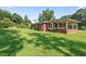 Charming brick home with a spacious backyard, featuring a covered porch for outdoor enjoyment at 3561 Clay Rd, Austell, GA 30106