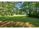 This large backyard is enhanced by mature trees offering a peaceful and private outdoor space at 3561 Clay Rd, Austell, GA 30106