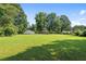 Expansive backyard featuring lush lawn, mature trees and an outbuilding, perfect for outdoor activities at 3561 Clay Rd, Austell, GA 30106