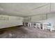 Unfinished basement with white painted walls, work bench, and natural light at 3561 Clay Rd, Austell, GA 30106