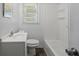 This bathroom features a toilet, sink, vanity and a shower tub combination at 3561 Clay Rd, Austell, GA 30106