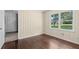 Bright bedroom featuring hardwood floors, panelling and a window with a view of the outdoors at 3561 Clay Rd, Austell, GA 30106