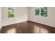 Inviting bedroom featuring gleaming hardwood floors and sun-drenched windows, creating a warm ambiance at 3561 Clay Rd, Austell, GA 30106