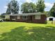 Charming brick home with a well-manicured lawn and mature trees at 3561 Clay Rd, Austell, GA 30106
