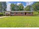 Charming brick home with a spacious front yard and lush green lawn, perfect for outdoor activities at 3561 Clay Rd, Austell, GA 30106