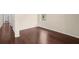 Hallway featuring hardwood floors and neutral walls, leading to various rooms in the home at 3561 Clay Rd, Austell, GA 30106