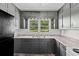 Kitchen boasting plenty of cabinets, counter space, and a window with a lovely backyard view at 3561 Clay Rd, Austell, GA 30106