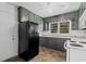 Kitchen featuring black appliances, ample cabinet storage, a large window and tile flooring at 3561 Clay Rd, Austell, GA 30106