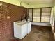 Functional laundry area with brick accent wall and natural light at 3561 Clay Rd, Austell, GA 30106