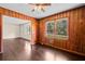Living room featuring a large window, wood walls, and hardwood flooring, creating a cozy space at 3561 Clay Rd, Austell, GA 30106