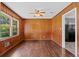 Cozy living room featuring paneled walls, hardwood floors, and a ceiling fan for added comfort at 3561 Clay Rd, Austell, GA 30106