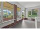 Bright sun room featuring brick accents and large windows offering serene views of the surrounding greenery at 3561 Clay Rd, Austell, GA 30106