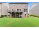 The home's backyard has a large, well-kept lawn, a patio, and it backs up to other homes at 4130 Millbrook Ct, Suwanee, GA 30024