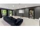 Finished basement featuring a comfortable seating area, a dark accent wall, and recessed lighting at 4130 Millbrook Ct, Suwanee, GA 30024