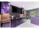 Basement bar featuring under-cabinet lighting, marble countertop, wine cooler, arcade game, and a television at 4130 Millbrook Ct, Suwanee, GA 30024