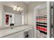 Bathroom featuring a single sink, decorative mirror, and a black, red, and tan striped shower curtain at 4130 Millbrook Ct, Suwanee, GA 30024